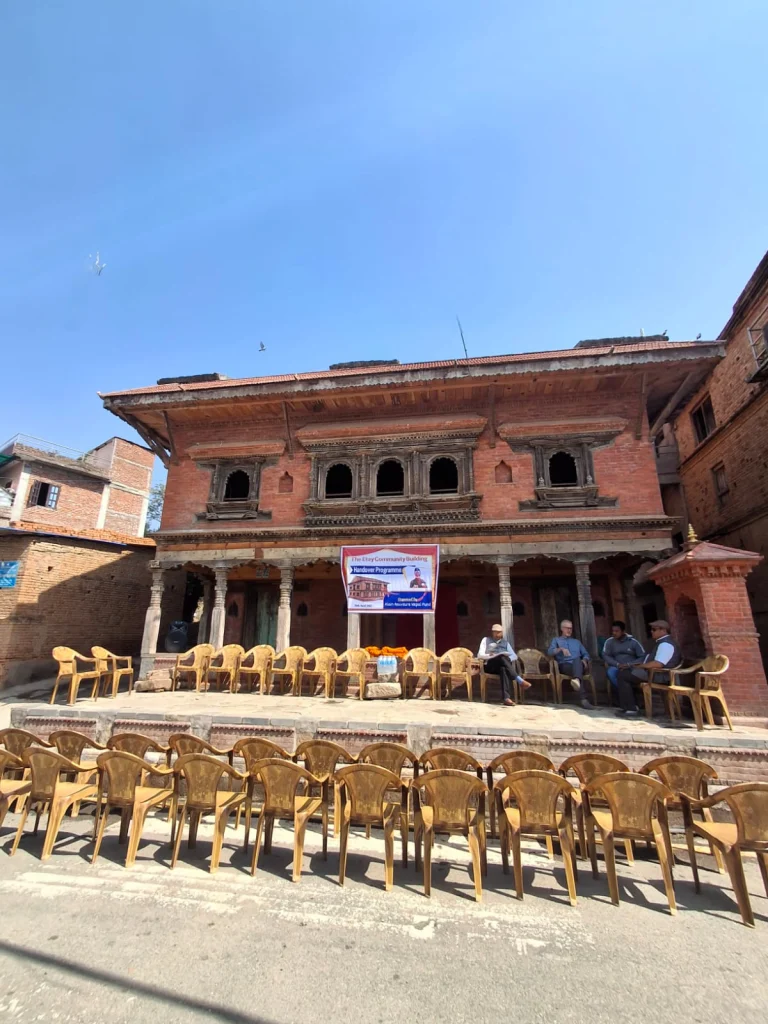 Rows of chairs set out on the street and the platform in front of the building before the handover ceremony